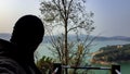 Man head shadow watching the pristine lake at morning