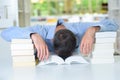 Man with head slumped in book Royalty Free Stock Photo