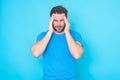 Man with headache, studio isolated portrait. Tired man having headache. Exhausted man feeling unhealthy, upset about