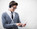 Man, headphones and listening to audio and phone for music by wall background, sound and peace. Male person, smartphone Royalty Free Stock Photo