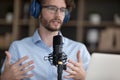 Man in headphones makes speech into microphone, closeup Royalty Free Stock Photo