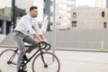 Man with headphones riding bicycle on city street Royalty Free Stock Photo