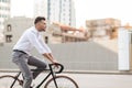 Man with headphones riding bicycle on city street Royalty Free Stock Photo