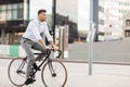 Man with headphones riding bicycle on city street Royalty Free Stock Photo