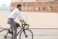 Man with headphones riding bicycle on city street Royalty Free Stock Photo