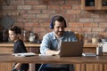 Man in headphones working online while little son running around Royalty Free Stock Photo