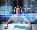 Man in headset hacking computer or programming