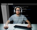 Man in headset hacking computer or programming Royalty Free Stock Photo