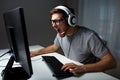 Man in headset playing computer video game at home Royalty Free Stock Photo