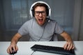 Man in headset playing computer video game at home Royalty Free Stock Photo