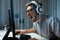 Man in headset playing computer video game at home Royalty Free Stock Photo