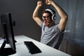 Man in headset playing computer video game at home Royalty Free Stock Photo