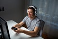 Man in headset playing computer video game at home Royalty Free Stock Photo