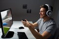 Man in headset playing computer video game at home Royalty Free Stock Photo