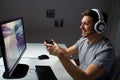 Man in headset playing computer video game at home Royalty Free Stock Photo