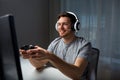 Man in headset playing computer video game at home Royalty Free Stock Photo