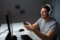 Man in headset playing computer video game at home Royalty Free Stock Photo