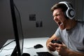 Man in headset playing computer video game at home Royalty Free Stock Photo