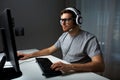 Man in headset playing computer video game at home Royalty Free Stock Photo