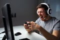 Man in headset playing computer video game at home Royalty Free Stock Photo