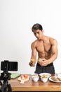 Man health and sports blogger showing healthy food menu while holding sweet potatoes