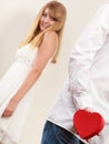 Man with heart shaped gift box for woman. Royalty Free Stock Photo