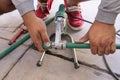 A man heats a polypropylene tube for cold and hot water