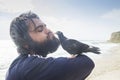 Man kissing pigeon Royalty Free Stock Photo