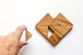 Man held piece of tangram puzzle to fulfill the heart shape