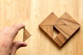 Man held piece of tangram puzzle to fulfill the heart shape on w