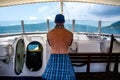 The man at the helm of the boat