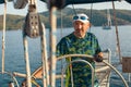 Man at helm leads a sailing yacht in the sea. Sport. Royalty Free Stock Photo