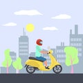 Man in helmet driving scooter on a city street. Royalty Free Stock Photo