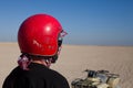 Man in helmet next to an ATV in desert Royalty Free Stock Photo