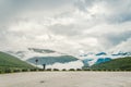 Man in helmet photographer taking photos back view of mountains landscape in rainy weather in Norway. Travel Lifestyle Royalty Free Stock Photo