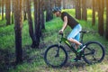 Man in a helmet riding on a green mountain bike in the woods. Cyclist in motion. Concept of active and healthy lifestyle Royalty Free Stock Photo