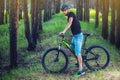 Man in a helmet riding on a green mountain bike in the woods. Cyclist in motion. Concept of active and healthy lifestyle Royalty Free Stock Photo