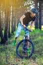 Man in a helmet riding on a mountain bike in the woods. Cyclist in motion. Concept of active and healthy lifestyle