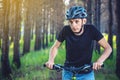 Man in a helmet riding on a mountain bike in the woods. Cyclist in motion. Concept of active and healthy lifestyle Royalty Free Stock Photo