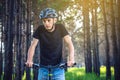 Man in a helmet riding on a mountain bike in the woods. Cyclist in motion. Concept of active and healthy lifestyle