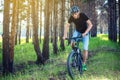 Man in a helmet riding on a mountain bike in the woods. Cyclist in motion. Concept of active and healthy lifestyle