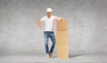 Man in helmet with tower of cardboard boxes