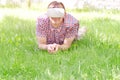 Man in a helmet of virtual reality lies on a green grass Royalty Free Stock Photo