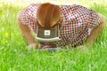 Man in a helmet of virtual reality lies on a green grass and looking down Royalty Free Stock Photo