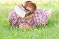 Man in a helmet of virtual reality lies on a green grass Royalty Free Stock Photo