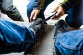 Man helping another man put on snow hiking acessories, partial v Royalty Free Stock Photo