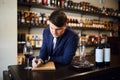 Man helping customers choose the correct wine for a meal or budget