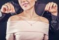 Man helping his girlfriend to try on a golden necklace. Gift for Valentines day.