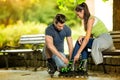 Man helping his girlfriends to put rollerblades