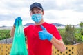 Man helping poor people giving them food and water in quarantine lockdown for the covid-19 - young adult working alone wearing Royalty Free Stock Photo